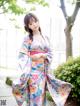 A woman in a kimono posing for a picture.